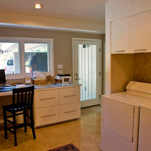 Design ideas for a large retro u-shaped utility room in Austin with flat-panel cabinets, white cabinets, glass worktops, beige walls, travertine flooring and a side by side washer and dryer.