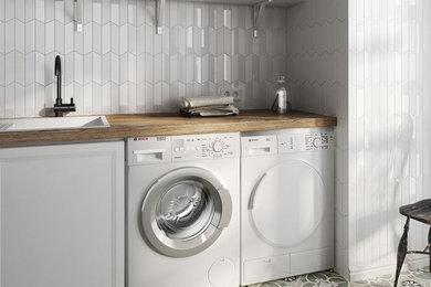 This is an example of a mid-sized contemporary single-wall dedicated laundry room in Chicago with a drop-in sink, wood benchtops, white walls, porcelain floors, a side-by-side washer and dryer and multi-coloured floor.
