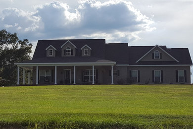 Example of a large classic gray two-story vinyl gable roof design in Birmingham