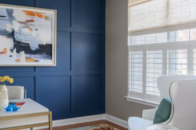 Example of a mid-sized transitional freestanding desk medium tone wood floor and orange floor study room design in Philadelphia with blue walls