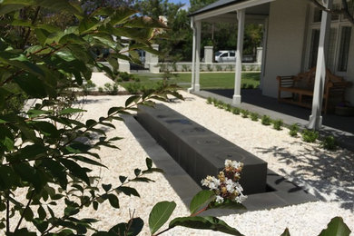 Photo of a mid-sized traditional front yard full sun formal garden for summer in Adelaide with natural stone pavers.