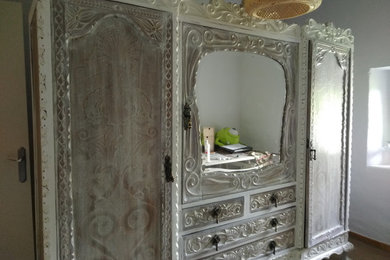 This is an example of an expansive country women's walk-in wardrobe in Bilbao with beaded inset cabinets and white cabinets.