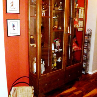 Idée de décoration pour un hall d'entrée bohème de taille moyenne avec un mur orange, un sol en bois brun, une porte double et une porte blanche.