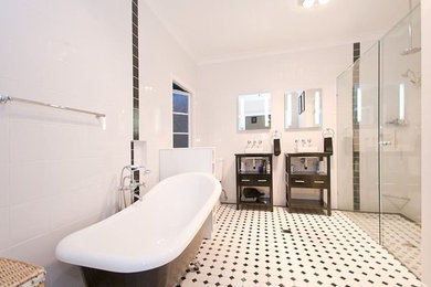 Design ideas for a large traditional master bathroom in Brisbane with a claw-foot tub, a double shower, a two-piece toilet, black tile, black and white tile, white tile, porcelain tile, white walls, ceramic floors and a vessel sink.