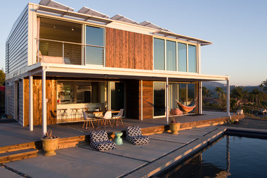 Example of a large trendy brown two-story wood flat roof design in San Diego