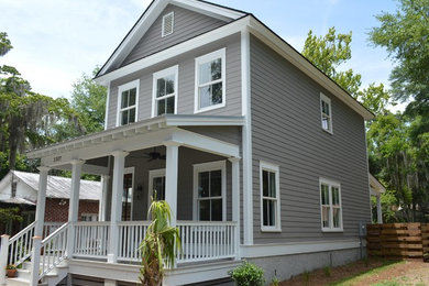 This is an example of a mid-sized traditional two-storey grey house exterior in Atlanta with wood siding, a gable roof and a shingle roof.