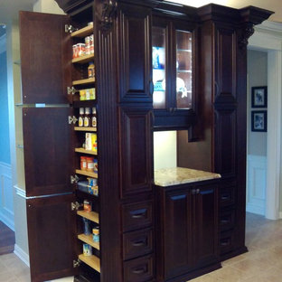 Traditional kitchen pantry remodeling - Example of a classic ceramic floor and beige floor kitchen pantry design in Cincinnati with raised-panel cabinets, dark wood cabinets, granite countertops and beige countertops