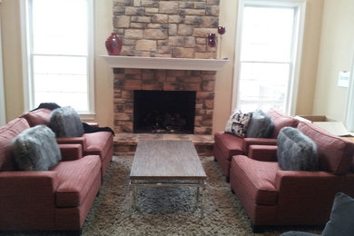 Family room - large transitional open concept medium tone wood floor family room idea in Chicago with a wall-mounted tv, beige walls, a standard fireplace and a stone fireplace