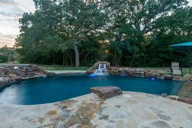 Inspiration for a large rustic backyard stone natural pool fountain remodel in Other