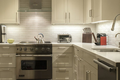 Kitchen - large contemporary dark wood floor kitchen idea in San Francisco with a drop-in sink, shaker cabinets, white cabinets and stainless steel appliances