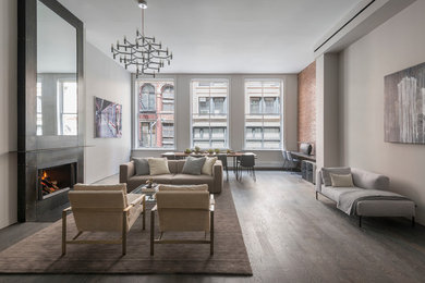 Living room - mid-sized modern formal and loft-style medium tone wood floor and brown floor living room idea in New York with gray walls, a ribbon fireplace, a metal fireplace and no tv