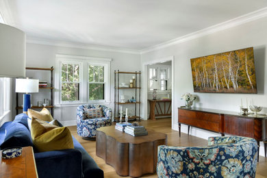 Living room - mid-sized transitional light wood floor living room idea in Minneapolis with beige walls and a wall-mounted tv