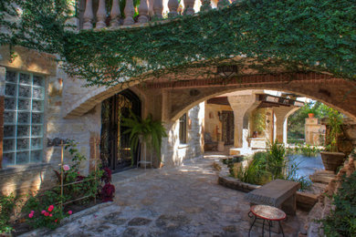 Tuscan home design photo in Austin