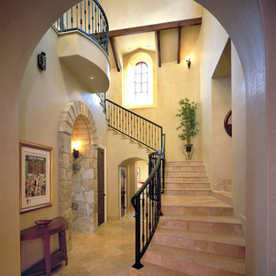 Mediterranean staircase in Austin with travertine treads and travertine risers.
