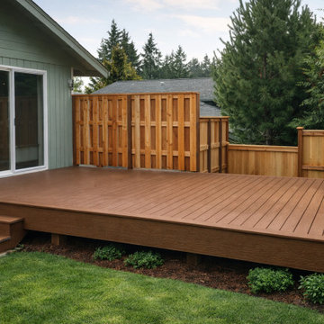 Flat Brown Composite Backyard Deck with Picture Frame Border in Olympia, WA