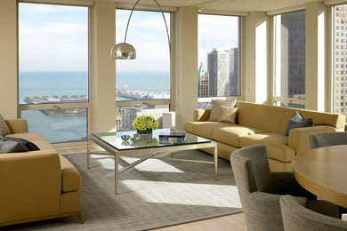 Large minimalist formal and loft-style light wood floor and beige floor living room photo in Chicago with beige walls, no fireplace and no tv
