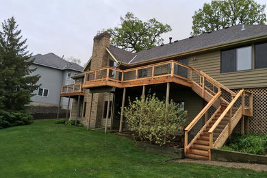 Example of a large arts and crafts beige two-story vinyl exterior home design in Minneapolis with a hip roof