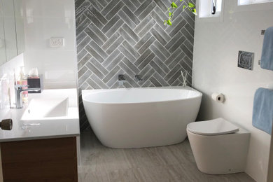 Design ideas for a large contemporary bathroom in Wollongong with white walls, bamboo floors, brown floor, recessed and panelled walls.