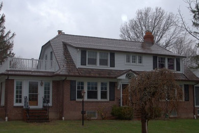 Traditional two-storey brown exterior in Cleveland with mixed siding.