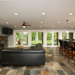 ワシントンD.C.の大きいトラディショナルスタイルのおしゃれな地下室 (半地下 (ドアあり)、グレーの壁、スレートの床、薪ストーブ) の写真