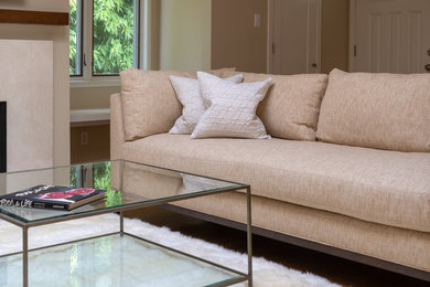 Example of a mid-sized trendy open concept medium tone wood floor and brown floor living room design in San Francisco with beige walls, a standard fireplace, a tile fireplace and a wall-mounted tv