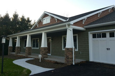 Inspiration for a mid-sized craftsman green one-story mixed siding exterior home remodel in Orange County with a shingle roof