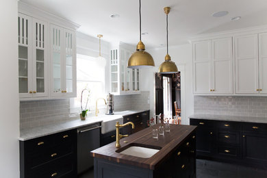 Example of a large transitional l-shaped slate floor and gray floor enclosed kitchen design in Orange County with a farmhouse sink, shaker cabinets, white cabinets, wood countertops, gray backsplash, subway tile backsplash, stainless steel appliances and an island