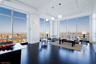 Example of a large trendy open concept dark wood floor living room design in New York with white walls and no tv