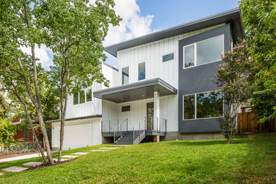 Example of a trendy white two-story mixed siding exterior home design in Austin with a shed roof
