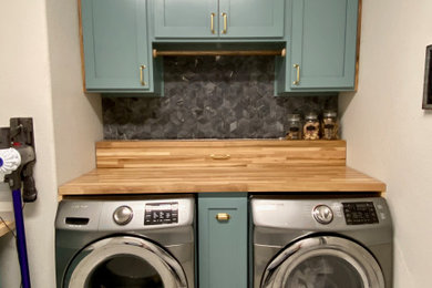 Dedicated laundry room - mid-sized eclectic porcelain tile and white floor dedicated laundry room idea in Austin with shaker cabinets, blue cabinets, wood countertops, black backsplash, gray walls and a side-by-side washer/dryer