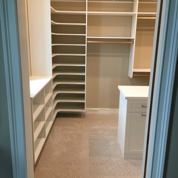 Master closet with corner shoe shelves and island - hourglass pole