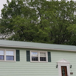 Metal Roof on Split-level Home - Roofing And Gutters