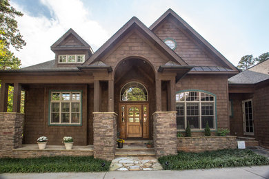 Large traditional brown two-story mixed siding exterior home idea