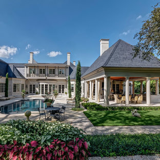 ダラスの大きい長方形トラディショナルスタイルのおしゃれなプール (天然石敷き) の写真