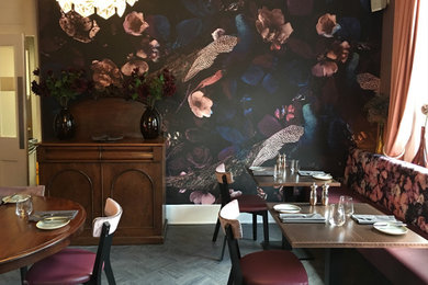 Inspiration for a medium sized bohemian open plan dining room in Other with multi-coloured walls, medium hardwood flooring, brown floors, wallpapered walls and a feature wall.