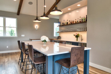 Inspiration for a modern single-wall medium tone wood floor, brown floor and vaulted ceiling eat-in kitchen remodel in Other with a single-bowl sink, shaker cabinets, blue cabinets, quartz countertops, white backsplash, stainless steel appliances, an island, white countertops and subway tile backsplash