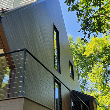 Deck with black metal post cable railing in Quebec, Canada