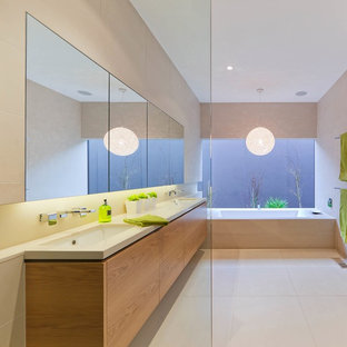 Photo of a modern bathroom in Melbourne with an undermount sink, flat-panel cabinets and medium wood cabinets.