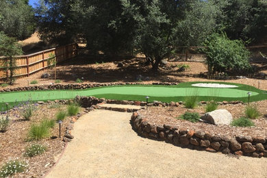 Inspiration for a large traditional backyard full sun outdoor sport court in Sacramento with a retaining wall and natural stone pavers.