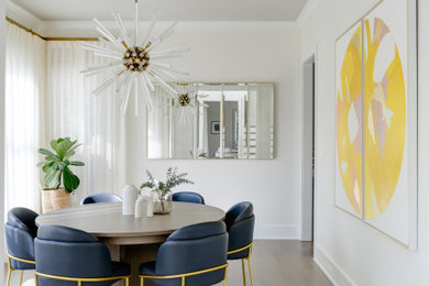 Example of a mid-sized minimalist medium tone wood floor and gray floor enclosed dining room design in DC Metro with white walls and no fireplace