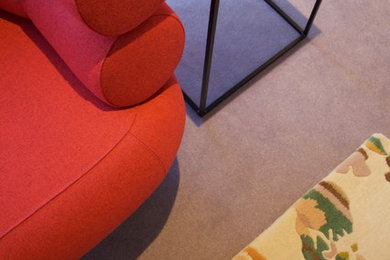 Design ideas for a medium sized contemporary formal mezzanine living room in London with carpet, no fireplace, beige walls and a built-in media unit.