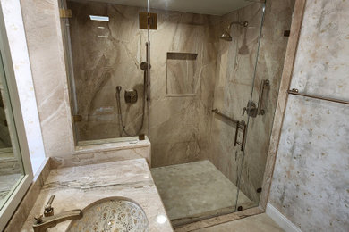 Walk-in shower - beige tile and marble tile single-sink walk-in shower idea in Las Vegas with beige cabinets, an undermount sink, marble countertops, a hinged shower door, beige countertops and a built-in vanity
