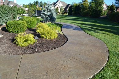 Design ideas for a mid-sized country backyard patio in St Louis with concrete slab and no cover.