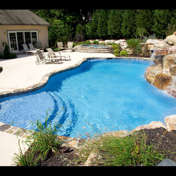 FREE FORM POOL WITH SEPARATE SPA WITH WATER FALL AND NATURAL STONE COPING