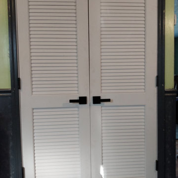 French style louver interior door with contemporary knobs.