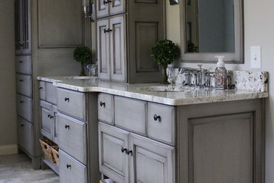 Inspiration for a large contemporary master porcelain tile and brown floor bathroom remodel in Other with raised-panel cabinets, gray cabinets, beige walls, an undermount sink and granite countertops