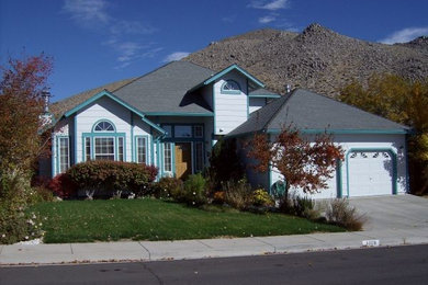 Example of a mid-sized white two-story wood exterior home design in Other