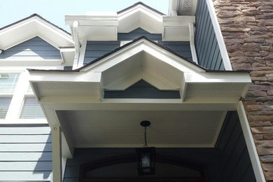 Photo of a large traditional two-storey blue exterior in Raleigh with mixed siding and a hip roof.