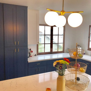 This is an example of a mid-sized modern u-shaped kitchen pantry in Los Angeles with an undermount sink, shaker cabinets, blue cabinets, quartzite benchtops, stainless steel appliances, porcelain floors, with island and blue floor.