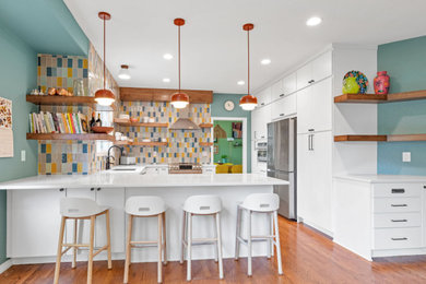 Kitchen - transitional kitchen idea in Denver with flat-panel cabinets, quartzite countertops, multicolored backsplash, porcelain backsplash and white countertops